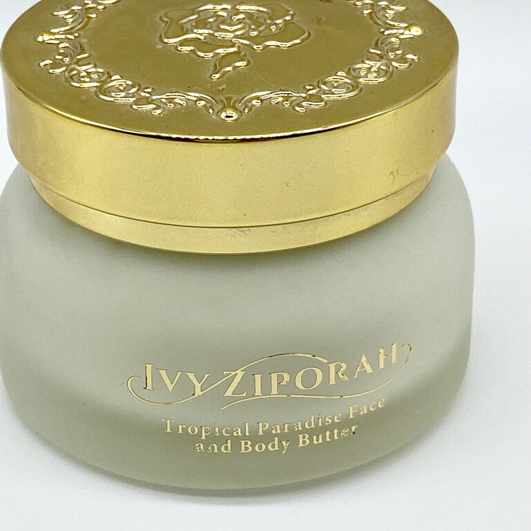 A jar of body butter sitting on top of a table.